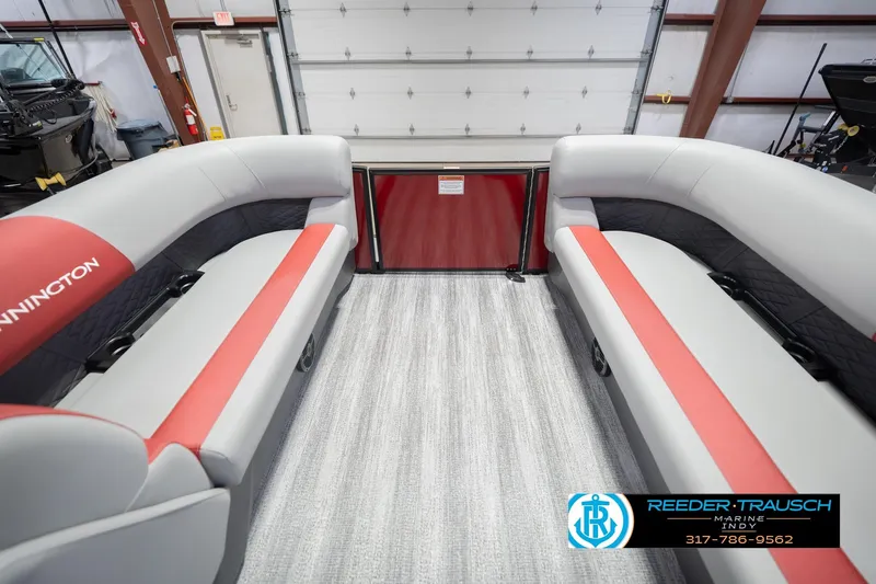 Slide: The Image of 2026 Bennington 22 SLJ boat interior with red and gray seating in a showroom. - 21