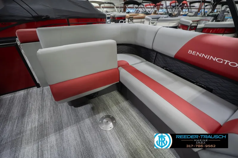 Slide: The Image of 2026 Bennington 22 SLJ boat interior with red and gray seating, showroom display. - 29