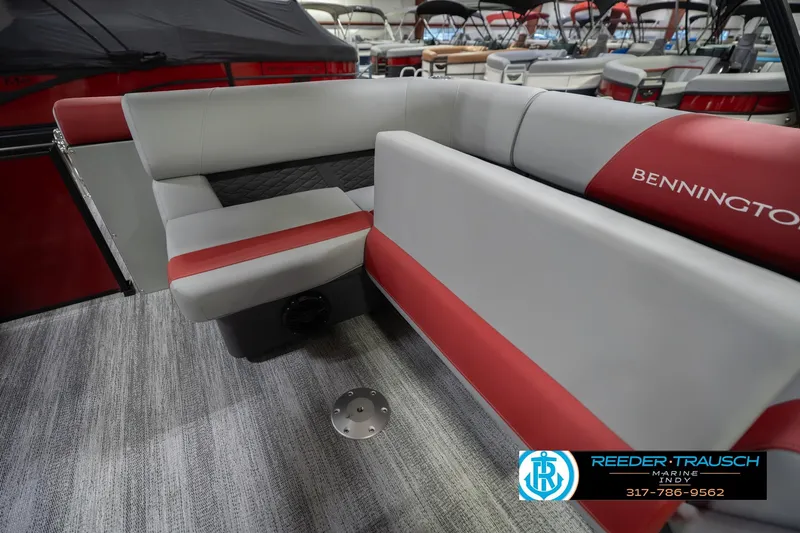 Slide: The Image of 2026 Bennington 22 SLJ boat interior with red and gray seating, showroom display. - 30