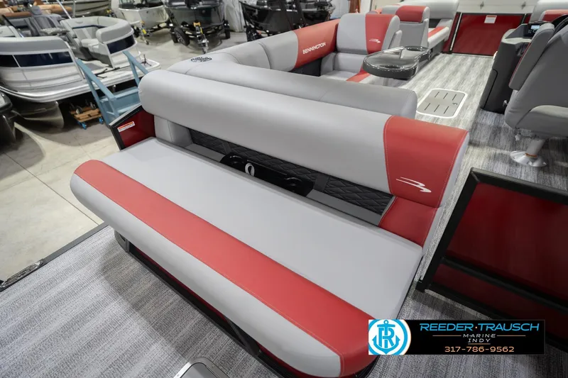 Slide: The Image of 2026 Bennington 22 SLJ pontoon boat interior with red and gray seating, displayed at Reeder-Trausch Marine. - 42