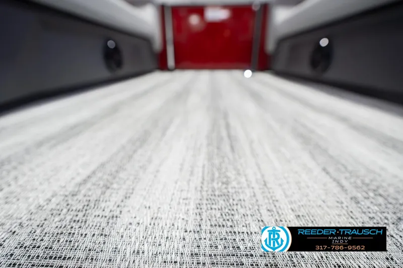 Slide: The Image of 2026 Bennington 22 SLJ boat interior flooring, featuring textured design and Reeder-Trausch Marine logo. - 46