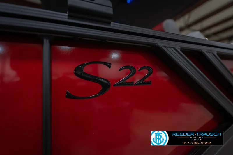 Slide: The Image of Red Bennington 22 SLJ boat with "S22" emblem, 2026 model, Reeder-Trausch Marine logo. - 48