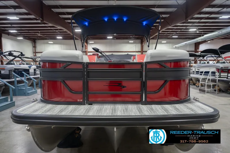 Slide: The Image of 2026 Bennington 22 SLJ pontoon boat in showroom, featuring red exterior and modern design. - 5