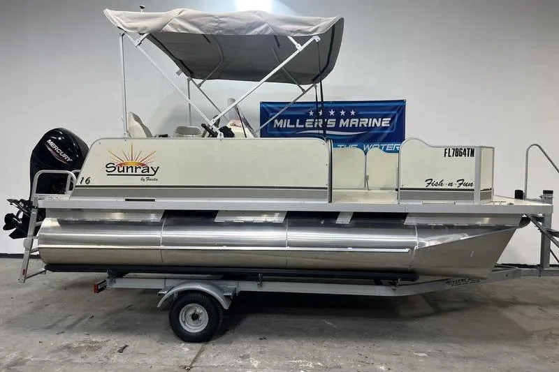 The Image of 2022 Fiesta 16 Fish N Fun pontoon boat with canopy and trailer in showroom. - 0