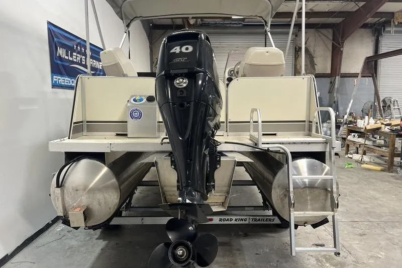 Slide: The Image of 2022 Fiesta 16 Fish N Fun pontoon boat with 40 HP motor in a workshop. - 4