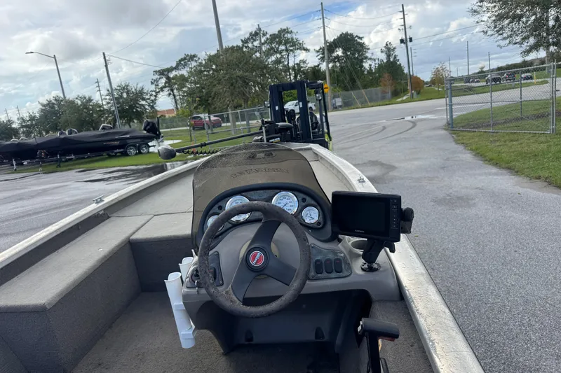 Slide: The Image of 2020 Tracker boat dashboard with steering wheel and navigation system in a parking area. - 10