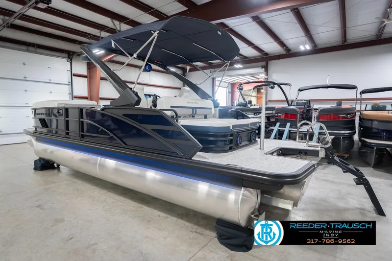 Slide: The Image of 2026 Bennington 24 MCSB pontoon boat in showroom, featuring sleek design and modern amenities. - 10