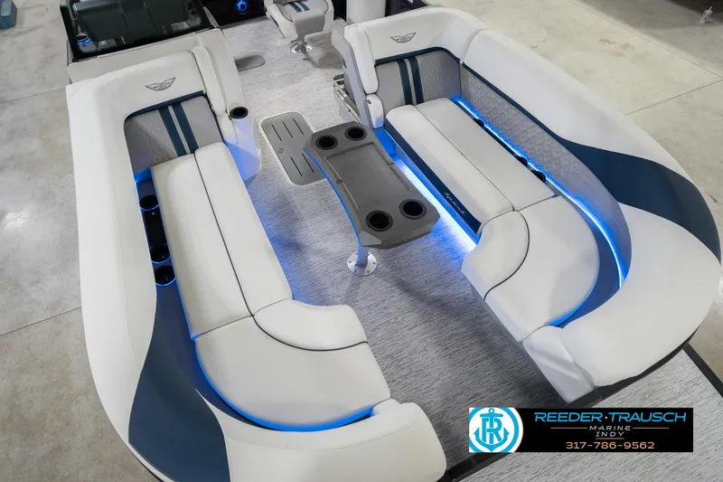 Slide: The Image of 2026 Bennington 24 MCSB boat interior with blue LED lighting and comfortable seating. - 13