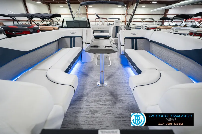 Slide: The Image of 2026 Bennington 24 MCSB boat interior with luxurious seating and ambient lighting. - 16