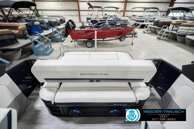 Slide: The Image of 2026 Bennington 24 MCSB boat interior with white seating in a showroom. - 18