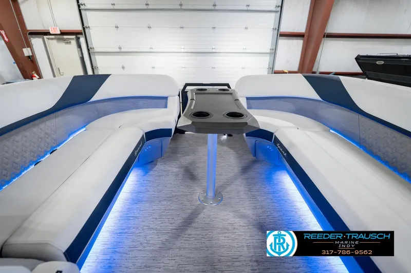 Slide: The Image of 2026 Bennington 24 MCSB boat interior with blue LED lighting and seating. - 21
