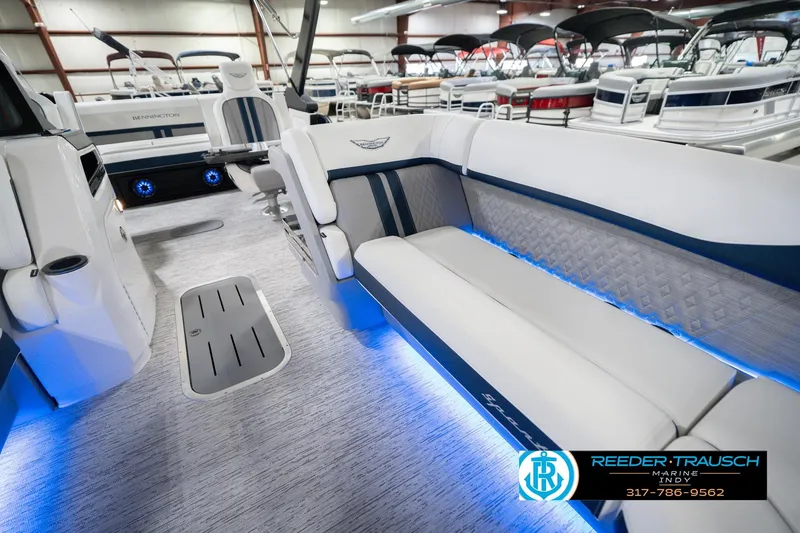 Slide: The Image of 2026 Bennington 24 MCSB boat interior with blue LED lighting and luxury seating. - 23