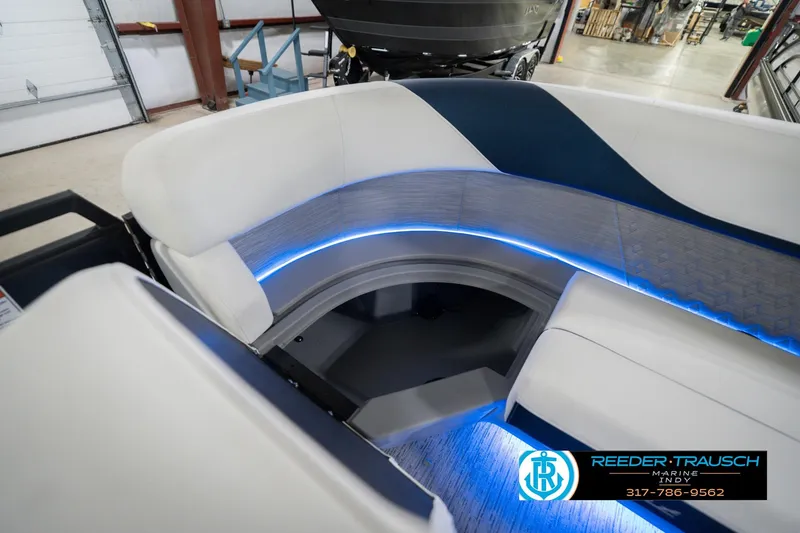 Slide: The Image of 2026 Bennington 24 MCSB boat interior with blue LED lighting and white seating. - 27