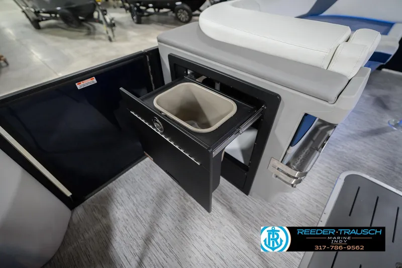 Slide: The Image of 2026 Bennington 24 MCSB boat interior with open storage compartment and trash bin. - 31