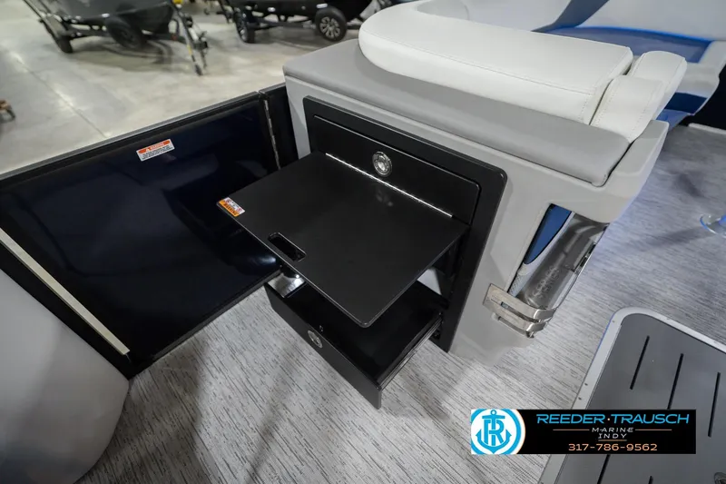 Slide: The Image of 2026 Bennington 24 MCSB boat interior with storage compartment and seating. - 32