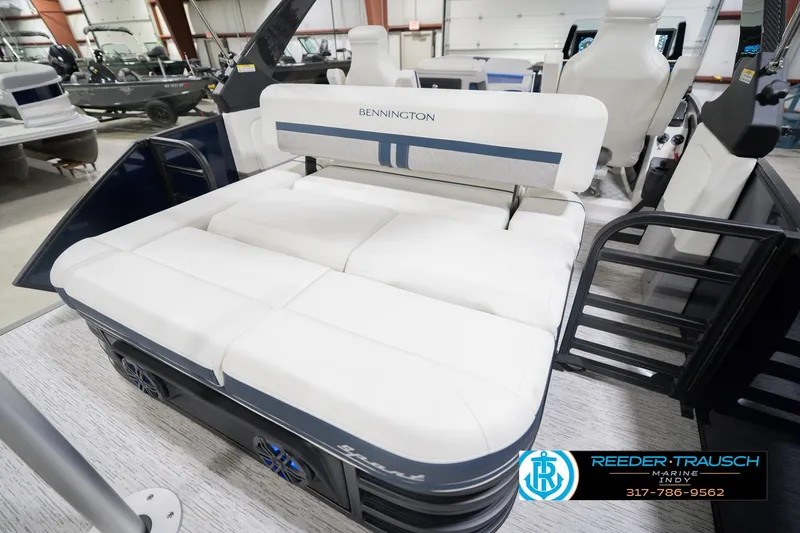 Slide: The Image of 2026 Bennington 24 MCSB boat interior with white seating in showroom. - 33