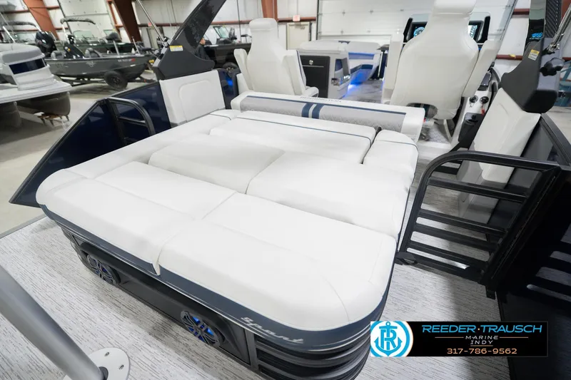 Slide: The Image of 2026 Bennington 24 MCSB boat interior with white seating, displayed at Reeder-Trausch Marine. - 34