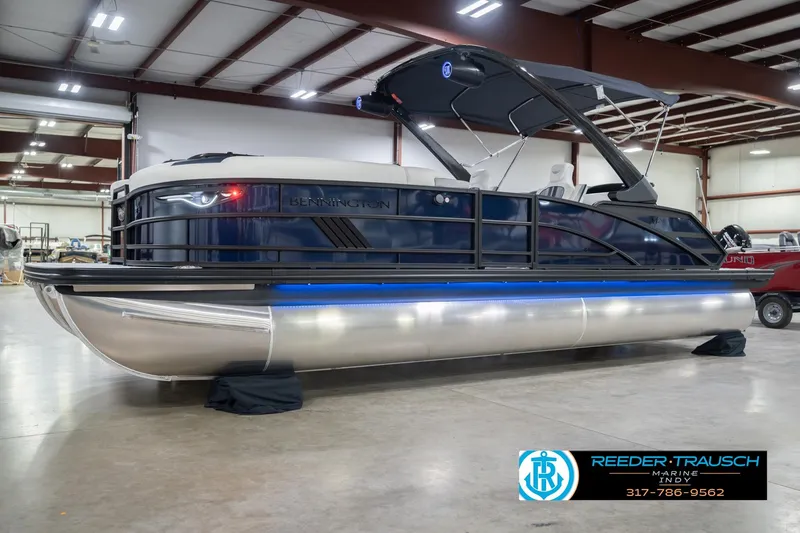 Slide: The Image of 2026 Bennington 24 MCSB pontoon boat in showroom, featuring sleek design and modern amenities. - 4