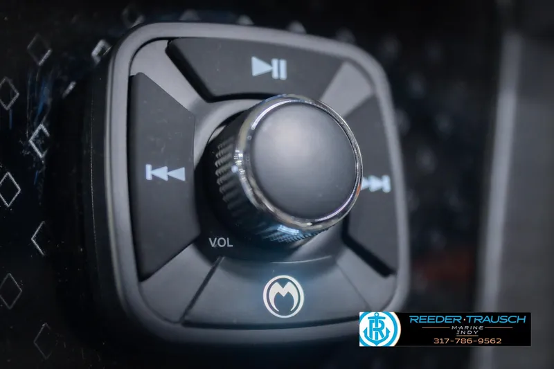Slide: The Image of Close-up of a 2026 Bennington 24 MCSB audio control knob with volume and playback buttons. - 41