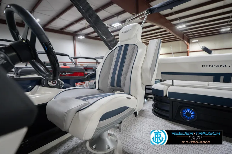 Slide: The Image of 2026 Bennington 24 MCSB boat interior with luxury seating and steering wheel. - 46