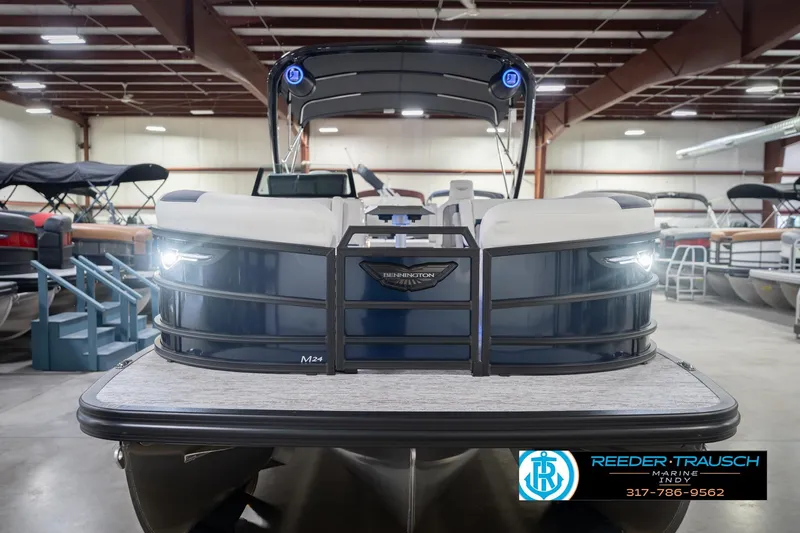 Slide: The Image of 2026 Bennington 24 MCSB pontoon boat displayed in a showroom. - 5