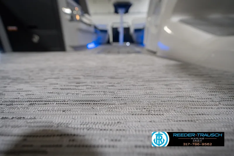 Slide: The Image of 2026 Bennington 24 MCSB boat interior with textured flooring and ambient lighting. - 55