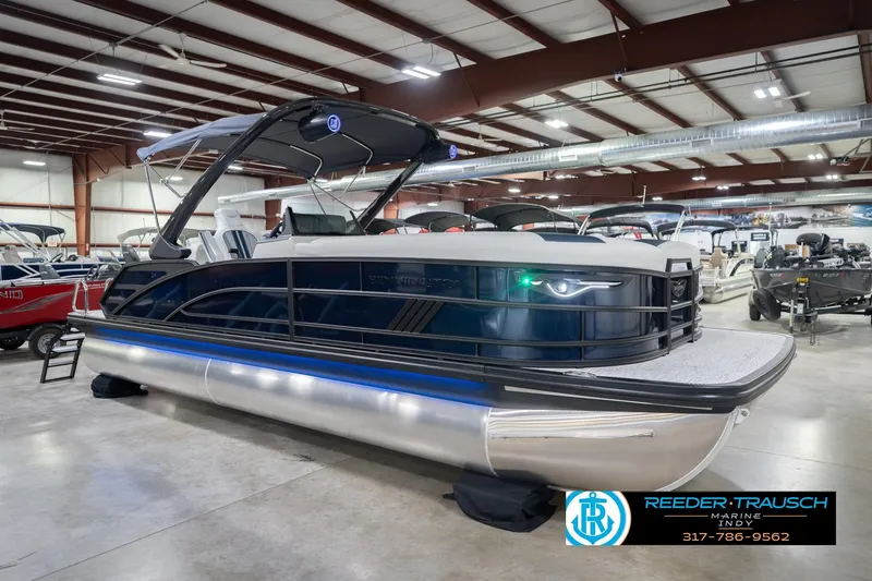 Slide: The Image of 2026 Bennington 24 MCSB pontoon boat displayed in a showroom. - 6