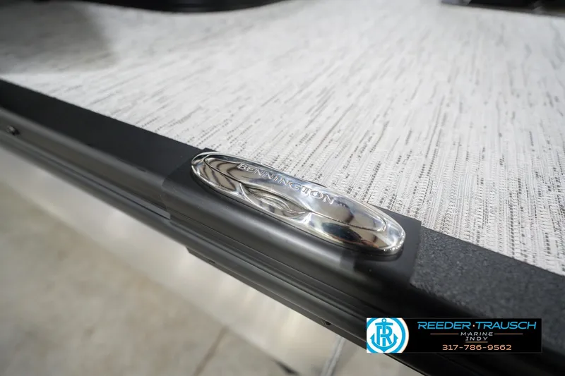 Slide: The Image of 2026 Bennington 24 MCSB boat detail with logo and textured surface. - 61