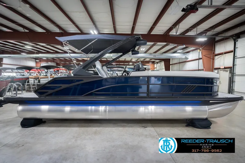 Slide: The Image of 2026 Bennington 24 MCSB pontoon boat in showroom, featuring sleek design and modern amenities. - 7