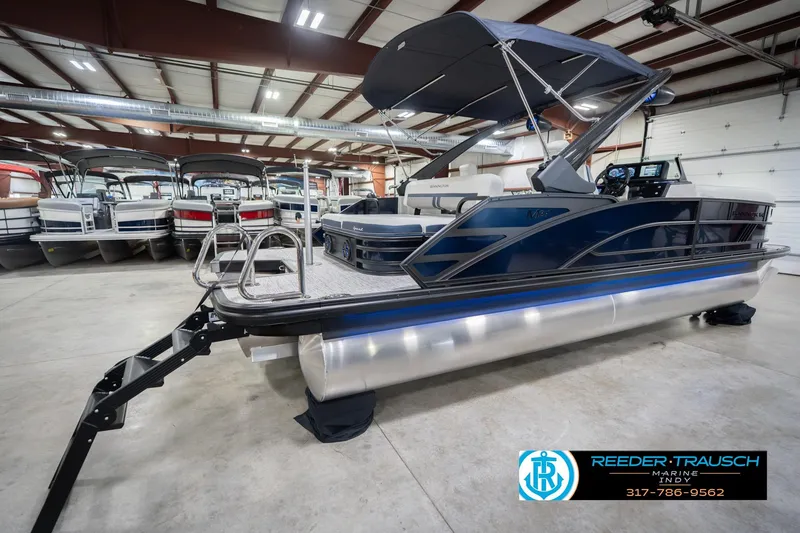 Slide: The Image of 2026 Bennington 24 MCSB pontoon boat in showroom, featuring sleek design and modern amenities. - 8