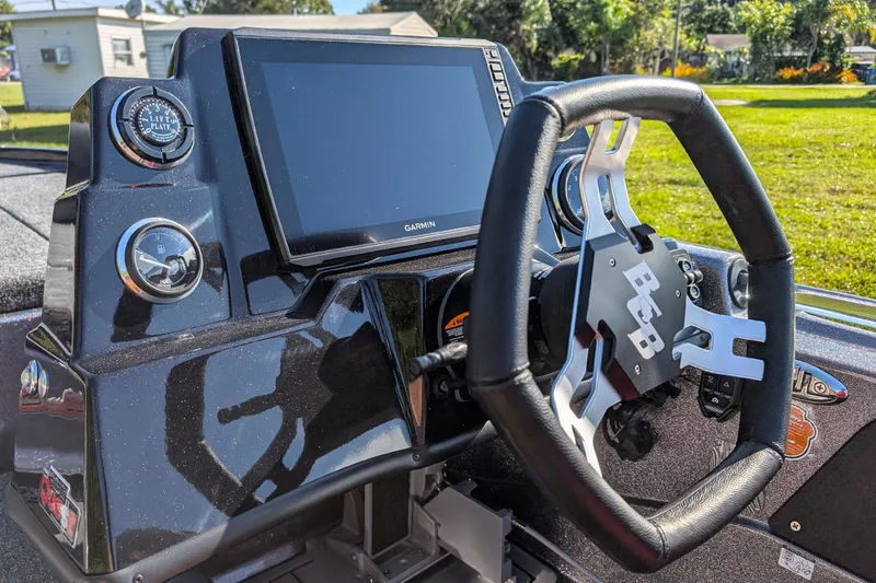 Slide: The Image of 2026 Bass Cat Eyra SP dashboard with steering wheel and Garmin display. - 10