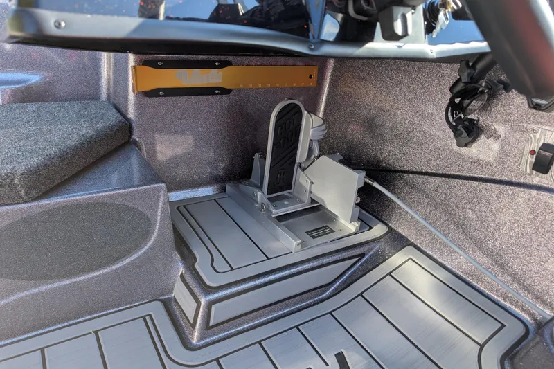 Slide: The Image of 2026 Bass Cat Eyra SP boat interior with foot pedal and textured flooring. - 15