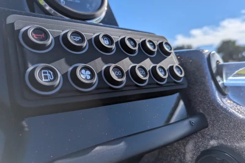 Slide: The Image of Control panel of 2026 Bass Cat Eyra SP boat with various function buttons. - 19