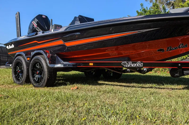 Slide: The Image of 2026 Bass Cat Eyra SP boat on grass, showcasing sleek design and vibrant colors. - 3