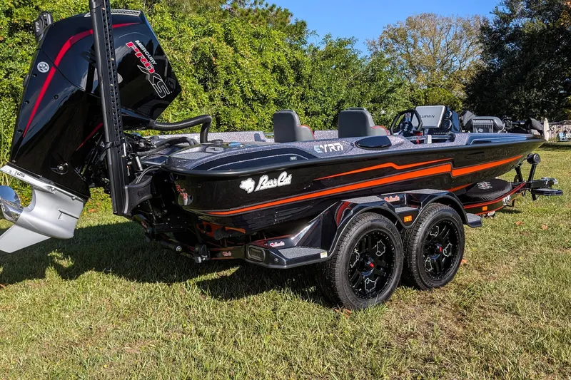Slide: The Image of 2026 Bass Cat Eyra SP boat with sleek design and powerful engine on grassy area. - 4