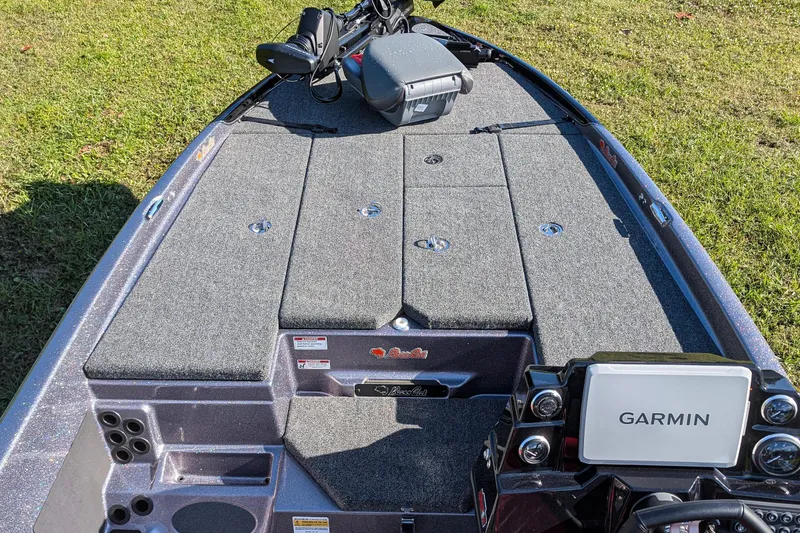 Slide: The Image of 2026 Bass Cat Eyra SP boat deck with Garmin system, on grassy background. - 9