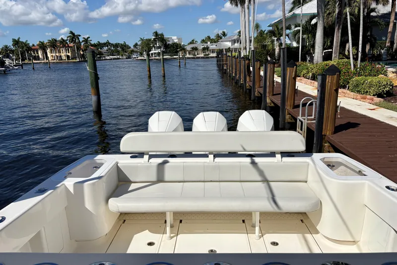 Slide: The Image of 2019 SeaVee 370z boat docked by a scenic waterfront with palm trees. - 10