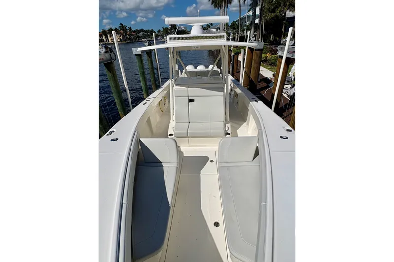 Slide: The Image of 2019 SeaVee 370z boat docked, featuring spacious seating and sleek design. - 11