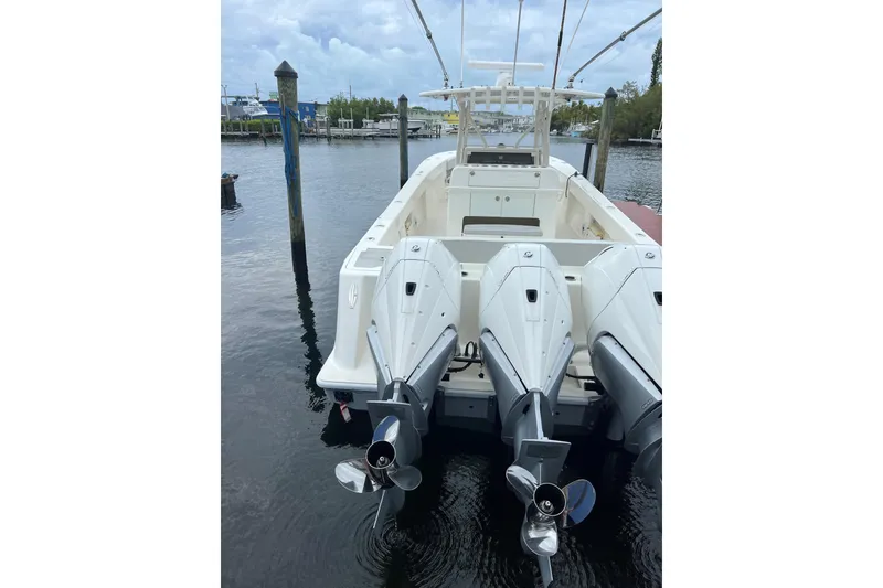 Slide: The Image of 2019 SeaVee 370z boat with triple outboard engines docked in a marina. - 5