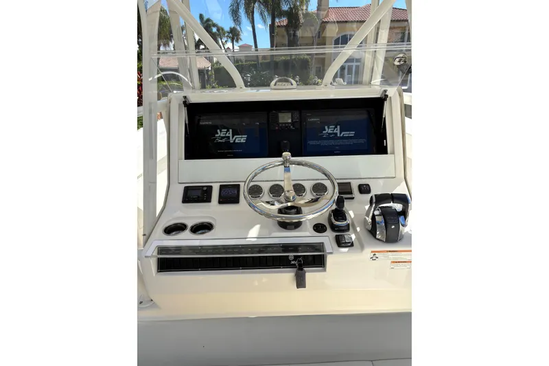 Slide: The Image of 2019 SeaVee 370z boat dashboard with steering wheel and navigation screens. - 8