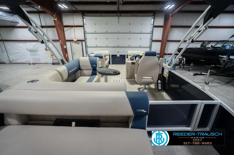 Slide: The Image of 2026 Bennington 21 SLJ pontoon boat interior in a warehouse setting. - 15