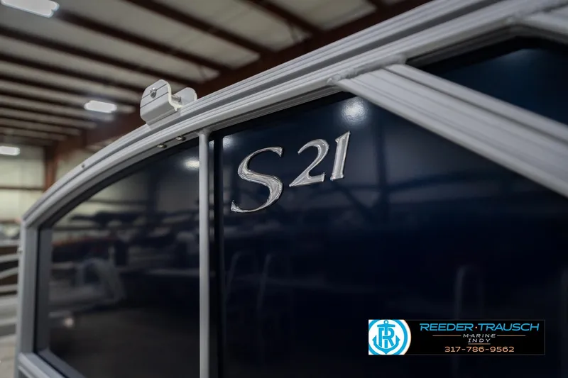 Slide: The Image of 2026 Bennington 21 SLJ boat in showroom, featuring sleek design and branding. - 46