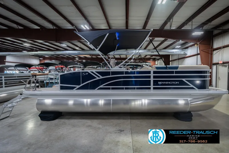 Slide: The Image of 2026 Bennington 21 SLJ pontoon boat displayed indoors at Reeder-Trausch Marine. - 7
