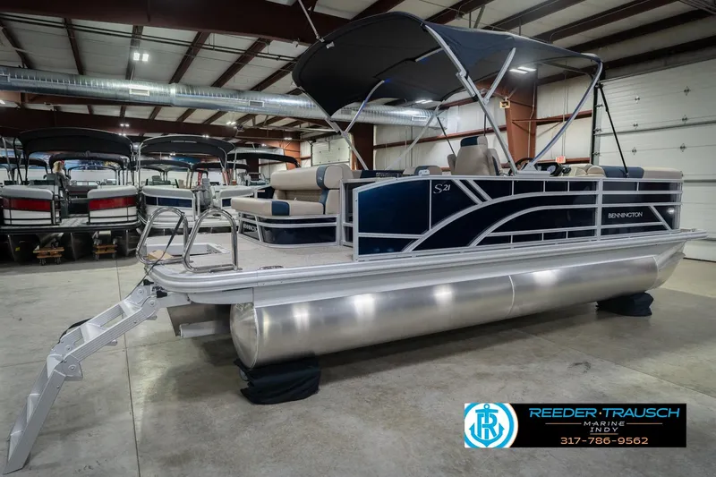 Slide: The Image of 2026 Bennington 21 SLJ pontoon boat in showroom with canopy and seating. - 8