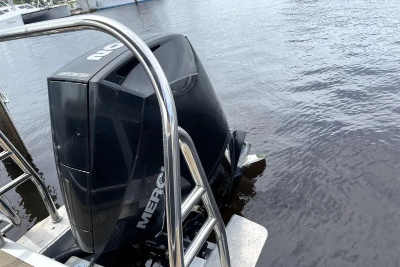 Slide: The Image of 2019 Harris Sunliner 250 with Mercury outboard engine on calm water. - 19