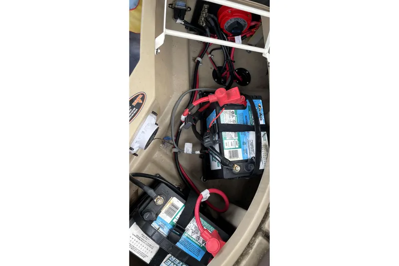 Slide: The Image of 2019 Harris Sunliner 250 boat battery compartment with wiring and connections. - 38
