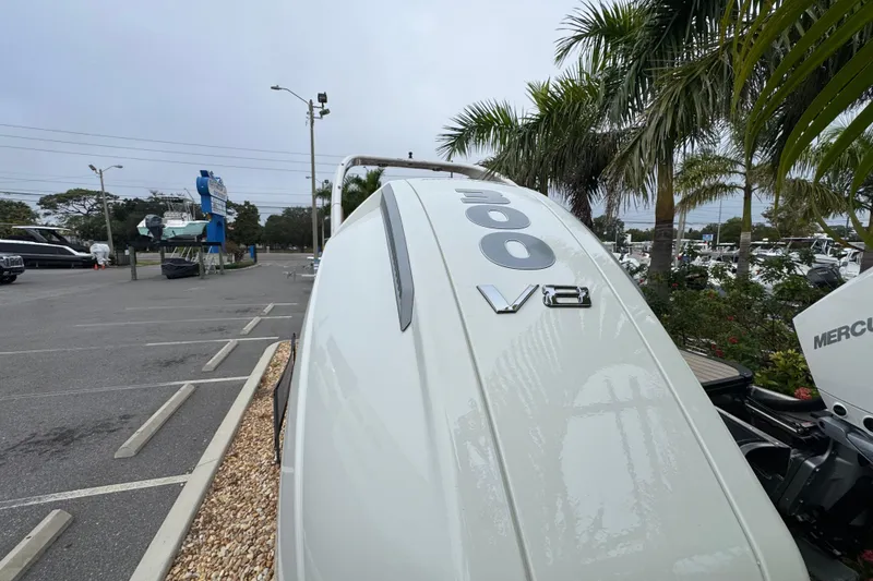 Slide: The Image of 2026 Avalon Excalibur 27' boat with 300 V8 engine, parked near palm trees. - 15