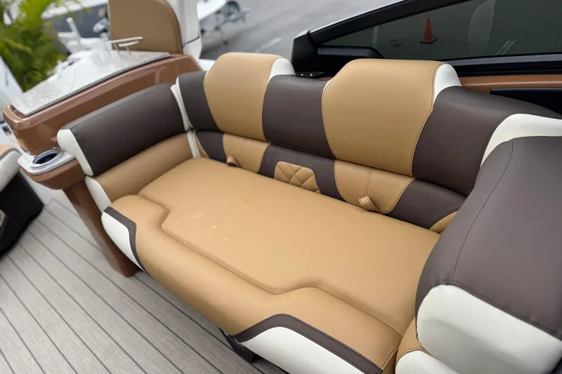 Slide: The Image of Luxurious seating on 2026 Avalon Excalibur 27' boat, featuring tan and brown upholstery. - 26
