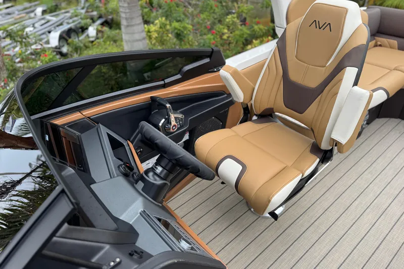 Slide: The Image of 2026 Avalon Excalibur 27' boat interior with luxurious captain's chair and modern dashboard. - 27