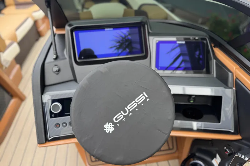 Slide: The Image of Steering wheel and dashboard of 2026 Avalon Excalibur 27' boat with Gussi Italia branding. - 29
